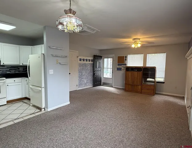 a view of a kitchen with furniture and a ceiling fan