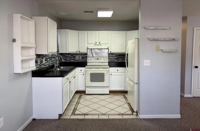 a utility room with cabinets washer and dryer