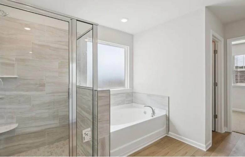 7231 Lyric Street Fairburn, GA 30213 - Photo 11 of 12 a bathroom with a bathtub and a shower
