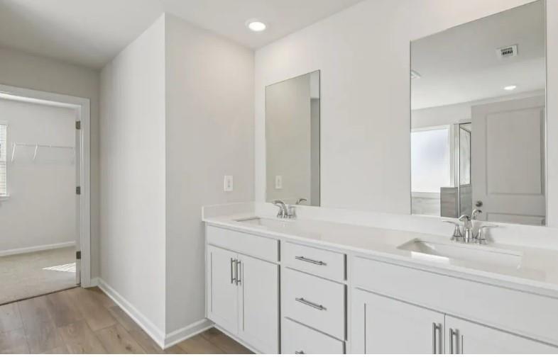 7231 Lyric Street Fairburn, GA 30213 - Photo 10 of 12 a bathroom with double sink and a mirror