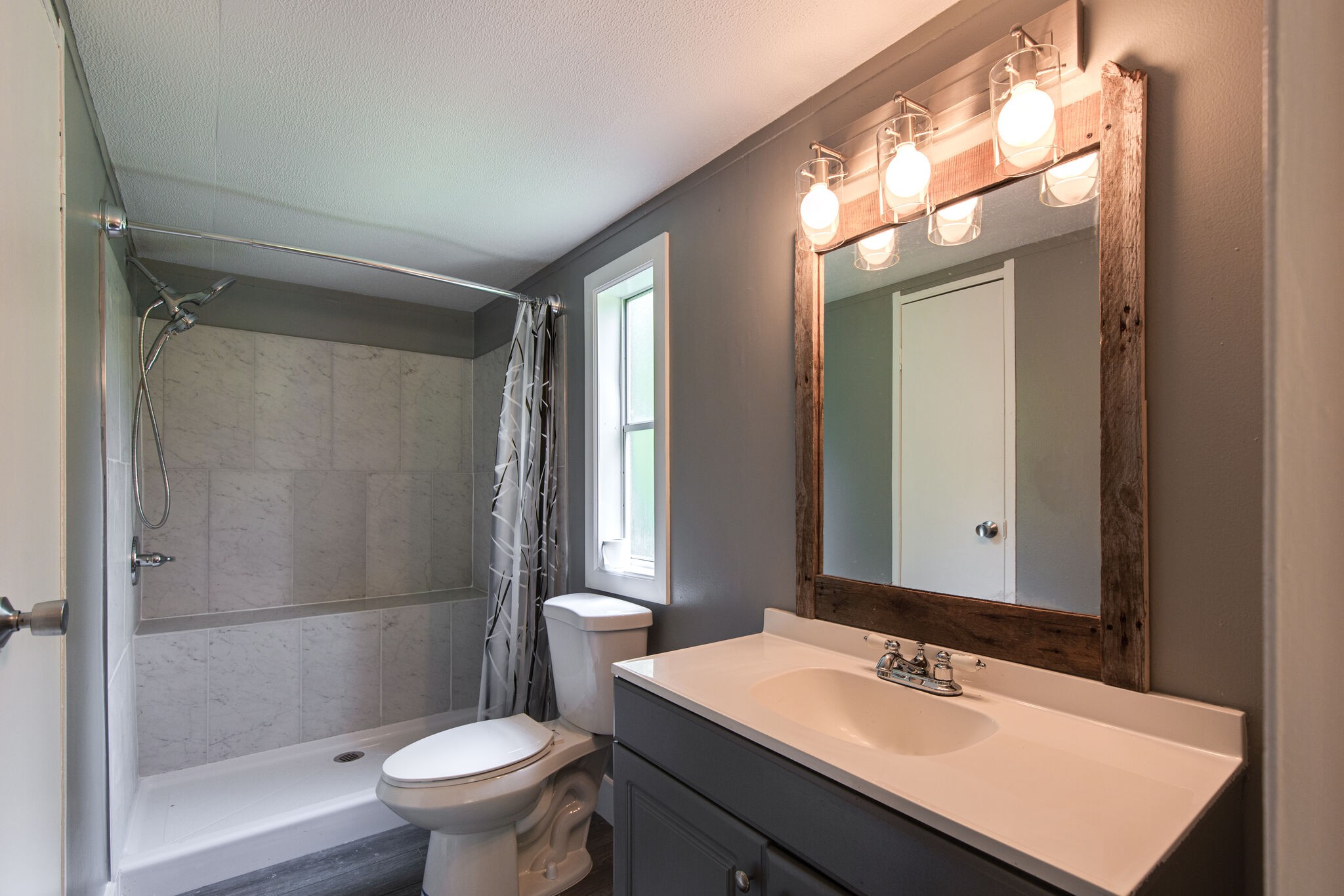 6571 Wesley Ridge Road Lyles, TN 37098 - Photo 18 of 23 a bathroom with a sink toilet mirror and shower
