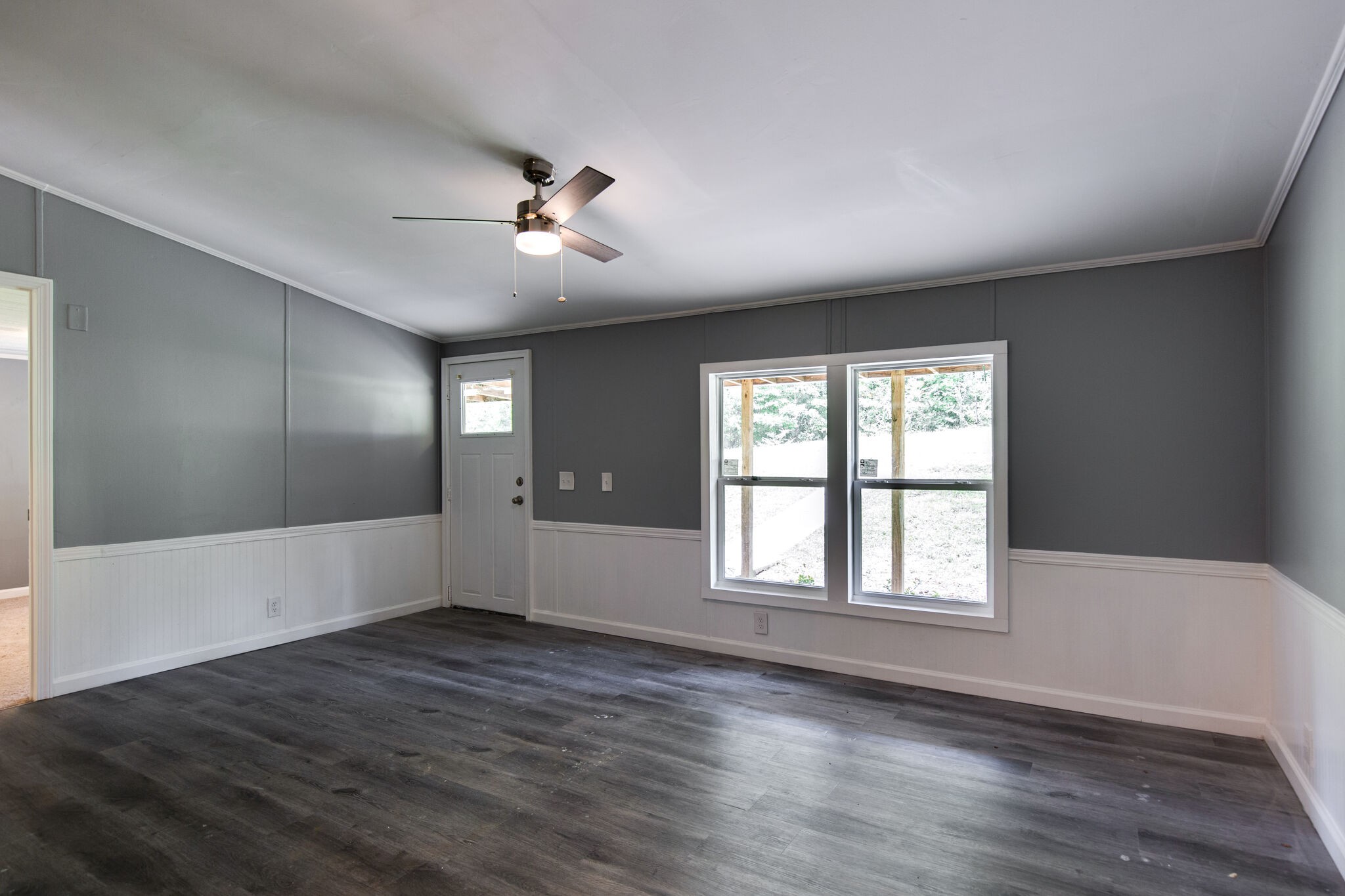 6571 Wesley Ridge Road Lyles, TN 37098 - Photo 5 of 23 a view of an empty room with wooden floor and a window