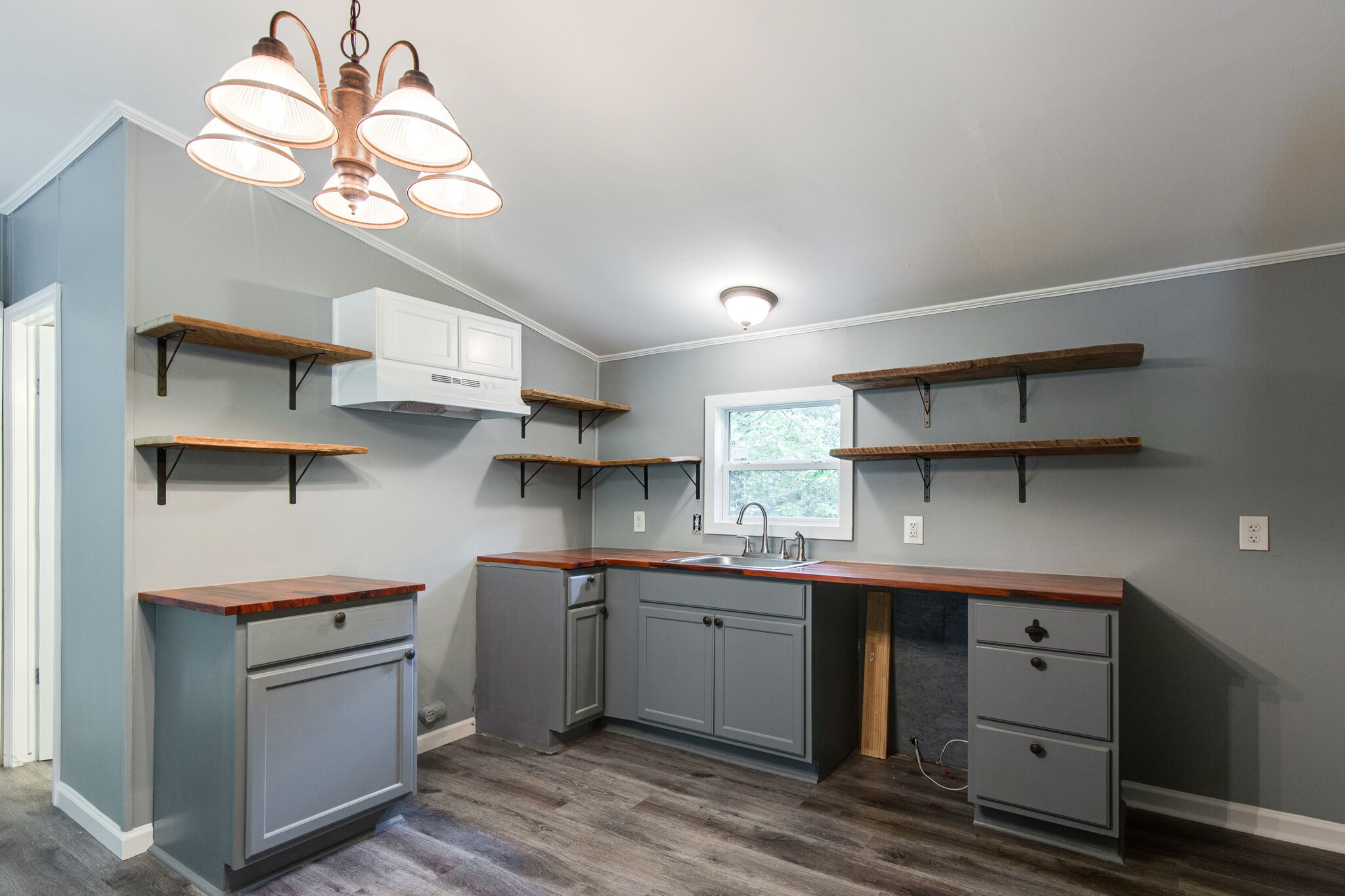6571 Wesley Ridge Road Lyles, TN 37098 - Photo 9 of 23 a kitchen with a sink a stove and cabinets