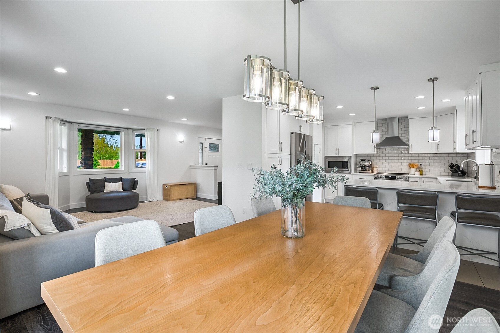 1939 Grandview Road Ferndale, WA 98248 - Photo 11 of 39 a view of a kitchen with kitchen island stainless steel appliances sink refrigerator dining table and chairs