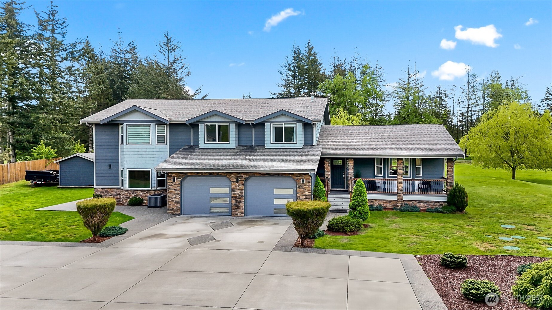 1939 Grandview Road Ferndale, WA 98248 - Photo 39 of 39 a front view of a house with a garden and trees