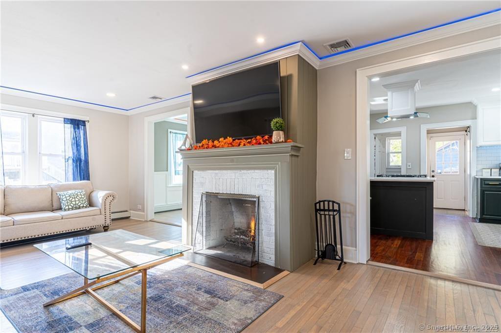18 Fenway Street Stamford, CT 06902 - Photo 1 of 1 a living room with furniture and a fireplace