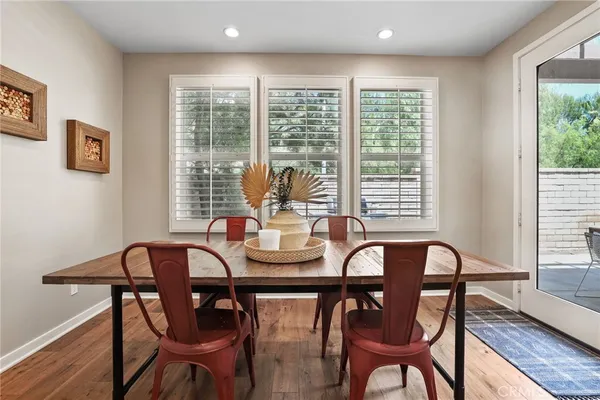 a view of a dining room with furniture window and wooden floor