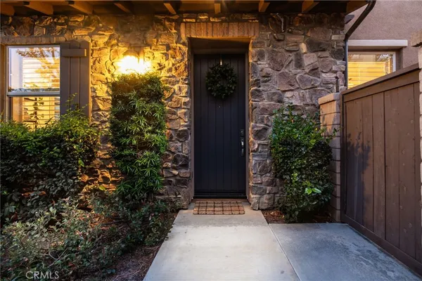 an entrance to house with yard and green space