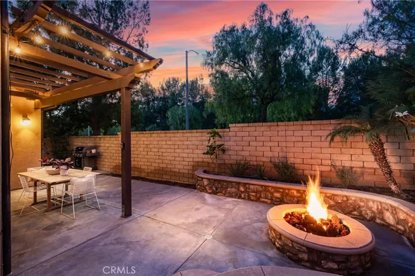a backyard of a house with table and chairs