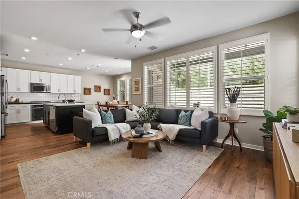 a living room with lots of furniture and kitchen view
