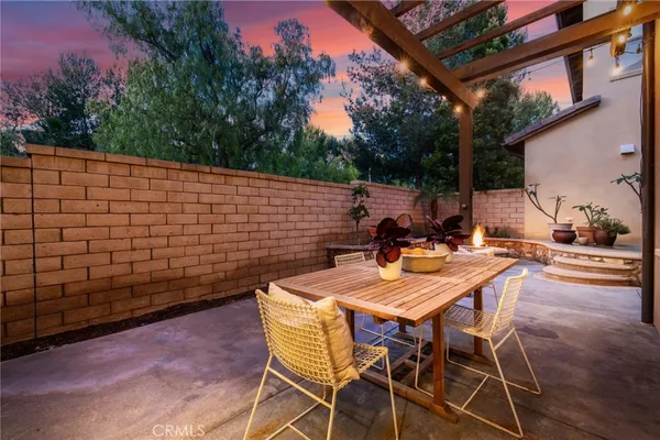 a view of a backyard with table and chairs and a fire pit