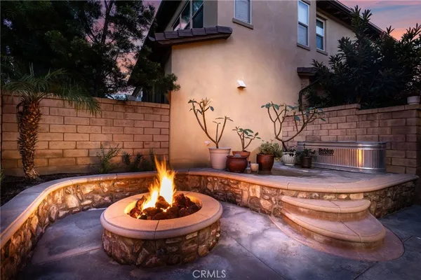 a view of a patio with a table and chairs and potted plants