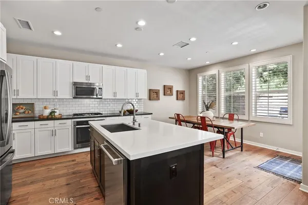 a kitchen with a stove sink and cabinets