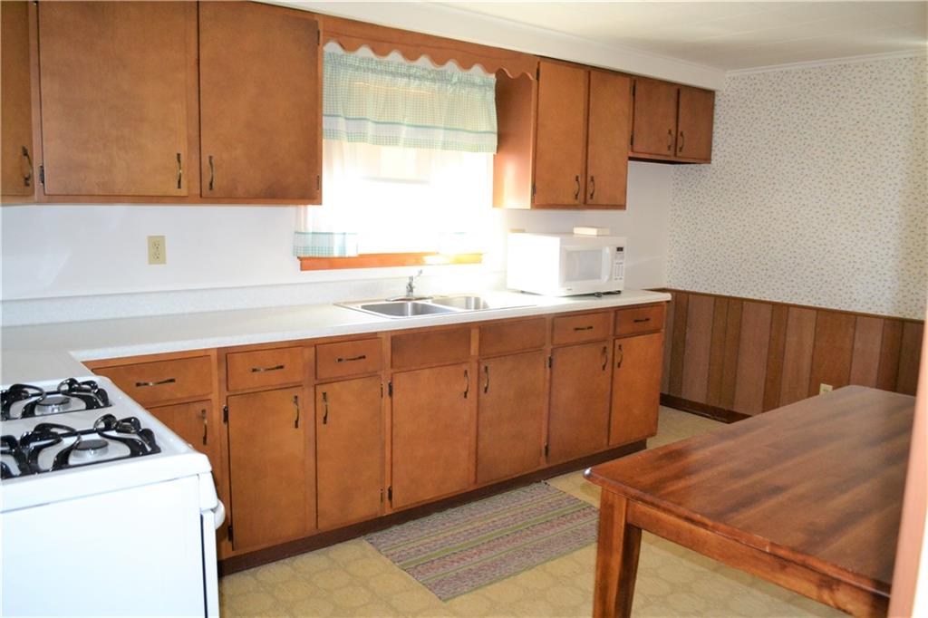 922 Main Street East Rural Valley, PA 16249 - Photo 5 of 20 a kitchen with a sink a stove and cabinets