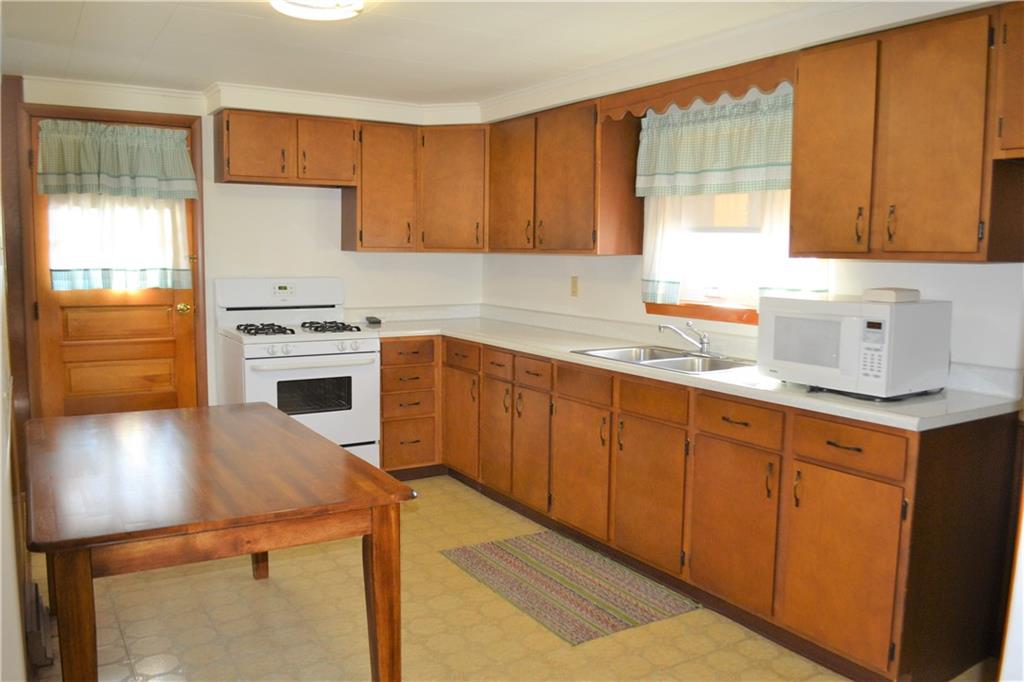 922 Main Street East Rural Valley, PA 16249 - Photo 6 of 20 a kitchen with stainless steel appliances granite countertop a sink stove and refrigerator