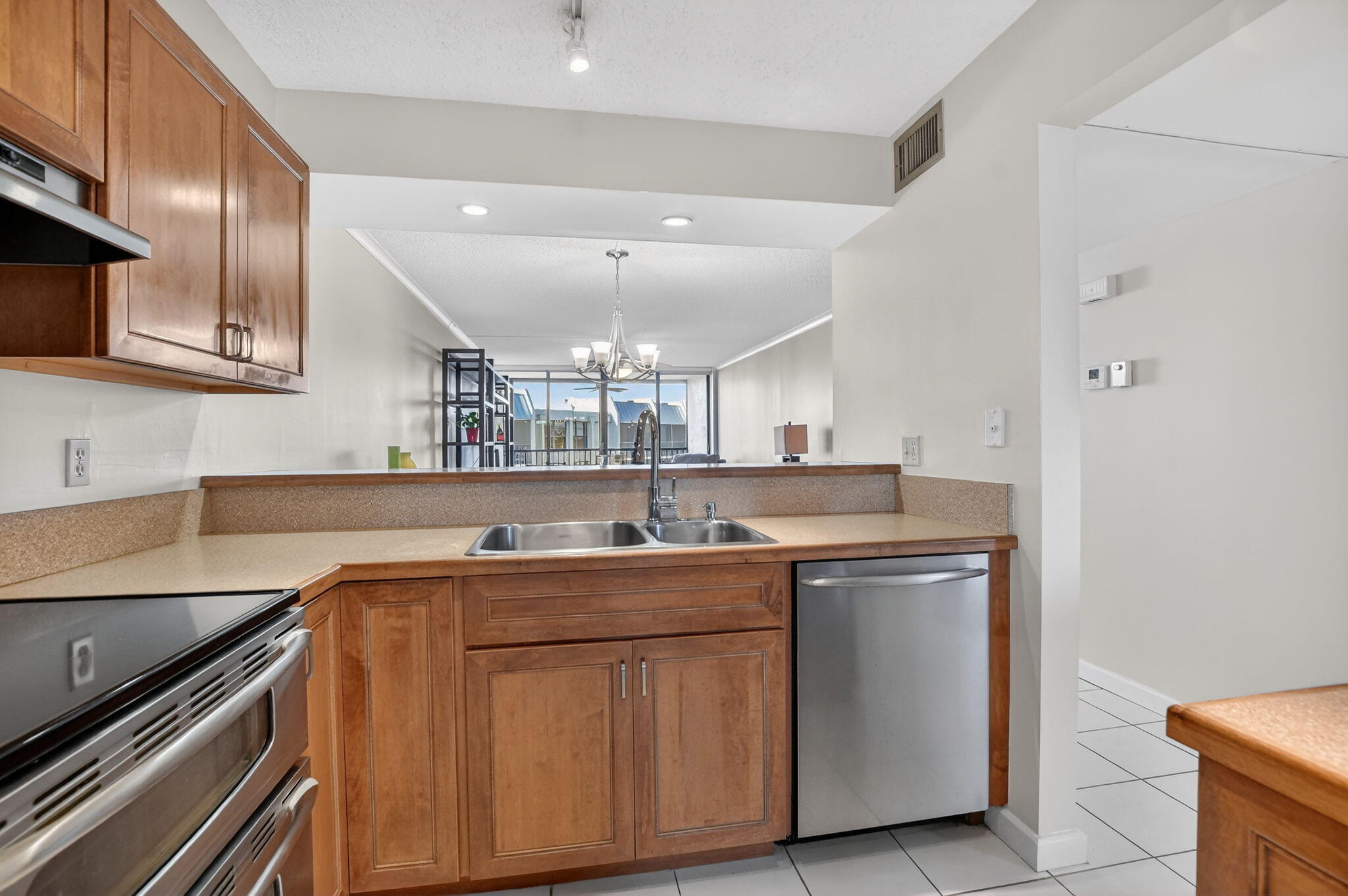 20 Royal Palm Way, Unit 602 Boca Raton, FL 33432 - Photo 15 of 56 a kitchen with kitchen island stainless steel appliances a sink stove and cabinets