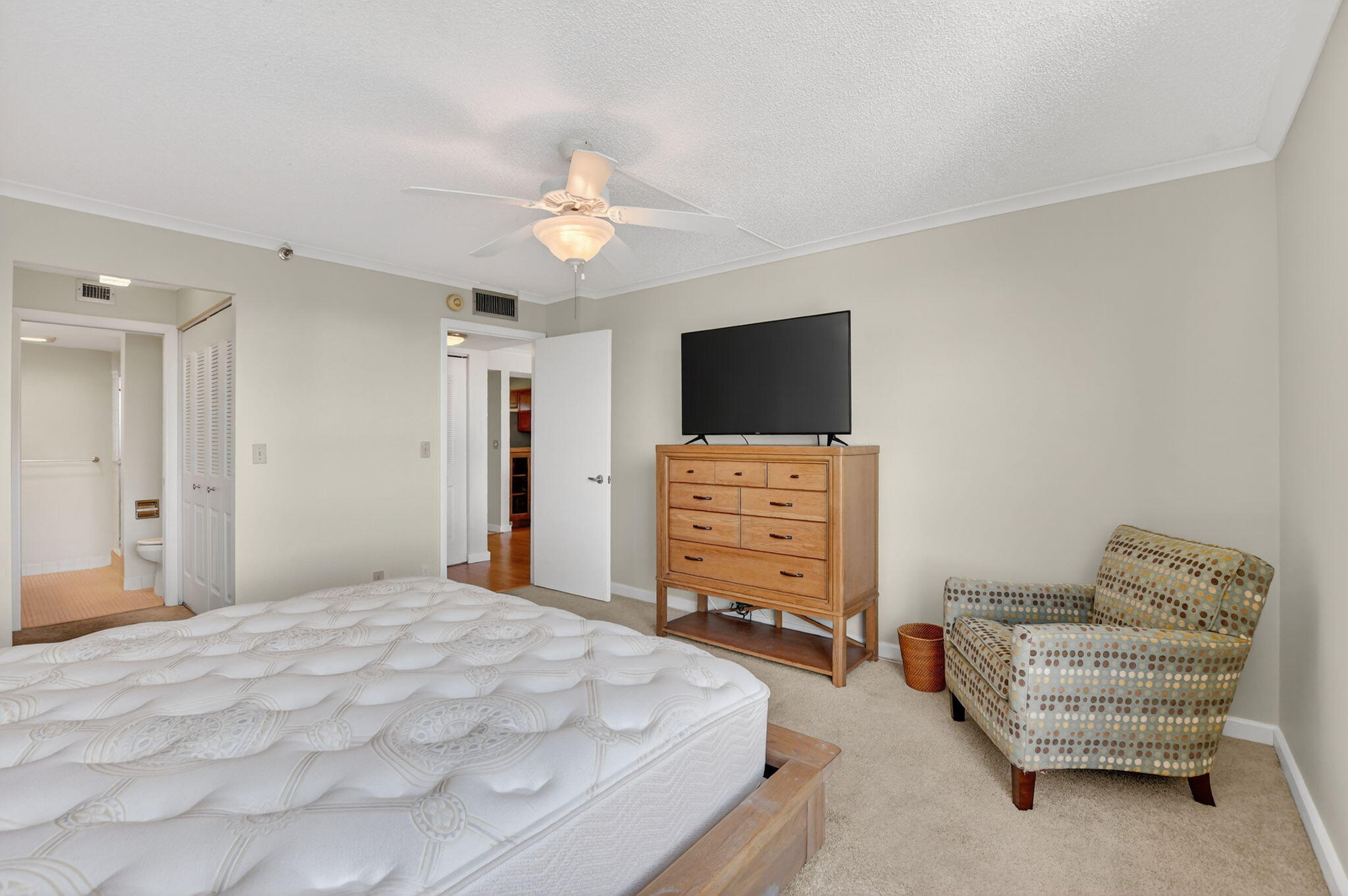 20 Royal Palm Way, Unit 602 Boca Raton, FL 33432 - Photo 24 of 56 a bedroom with furniture and a flat screen tv
