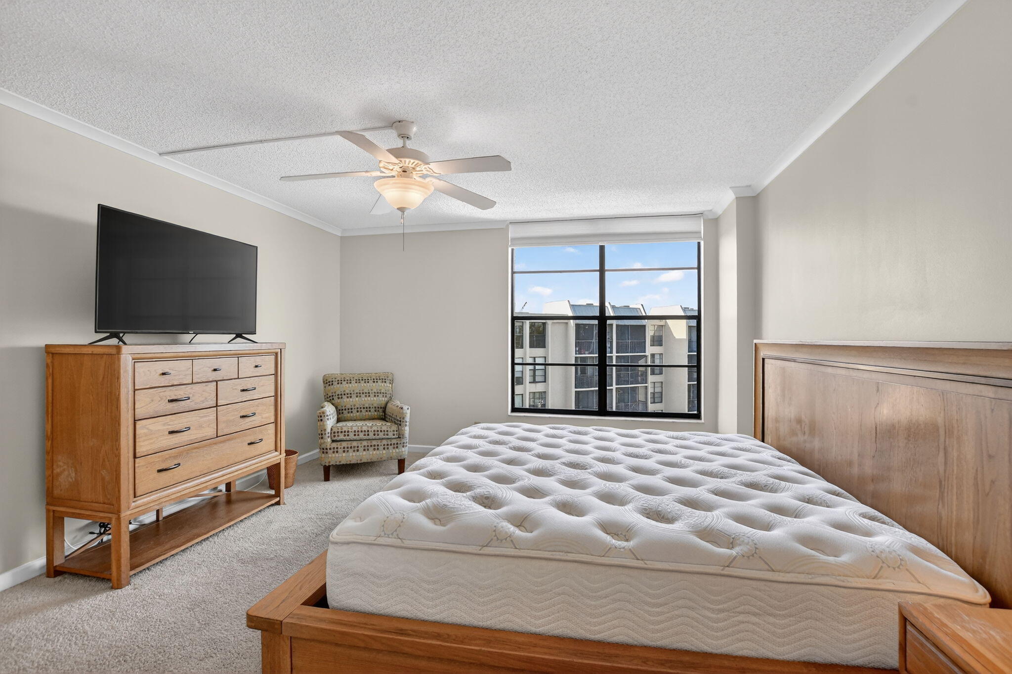 20 Royal Palm Way, Unit 602 Boca Raton, FL 33432 - Photo 25 of 56 a bedroom with a large bed and flat tv screen on dresser
