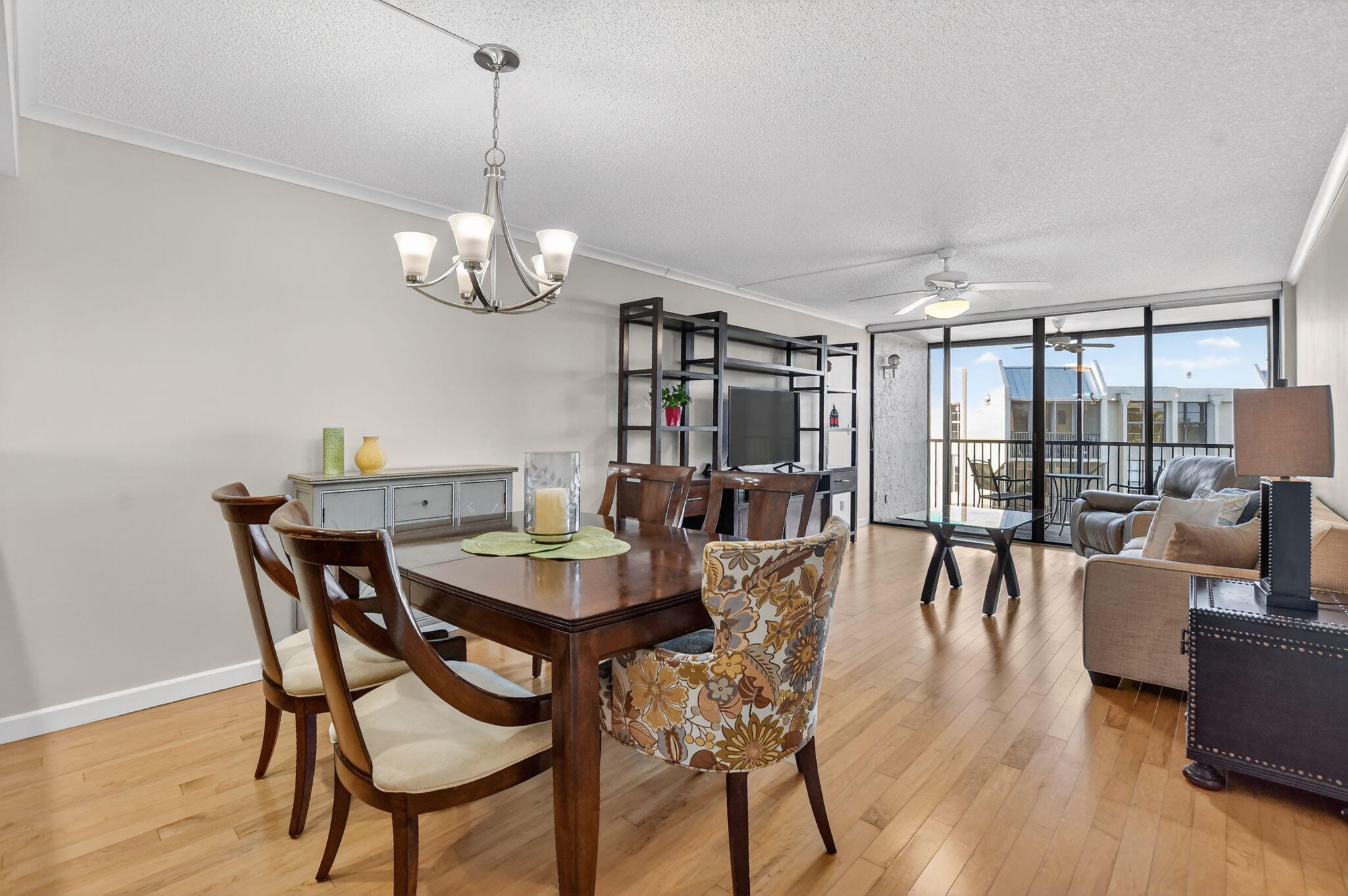 20 Royal Palm Way, Unit 602 Boca Raton, FL 33432 - Photo 6 of 56 a view of a dining room with furniture wooden floor and chandelier