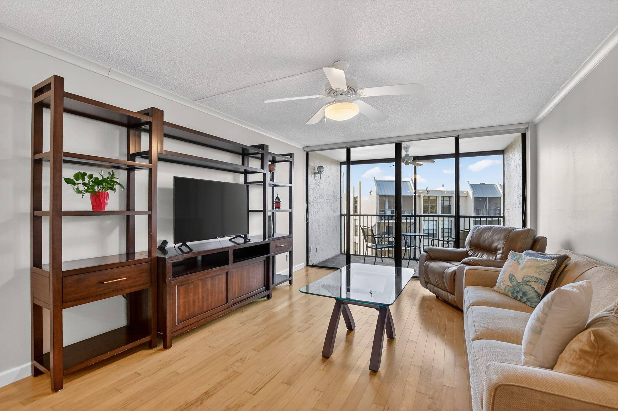 20 Royal Palm Way, Unit 602 Boca Raton, FL 33432 - Photo 10 of 56 a living room with furniture a flat screen tv and a floor to ceiling window