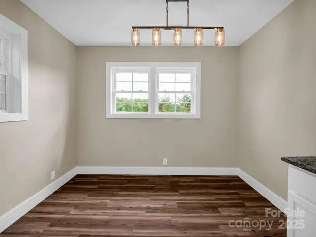 a view of wooden floor and window in a room
