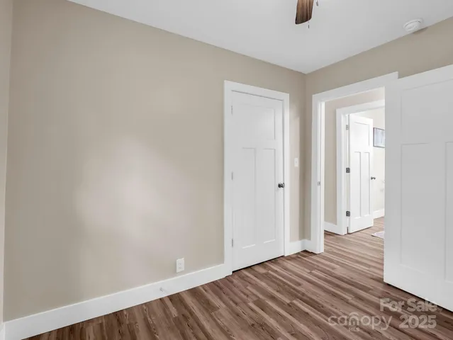 a view of an empty room with wooden floor