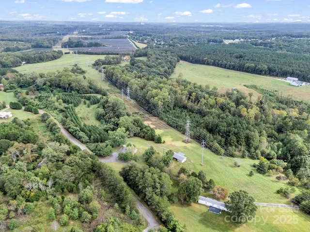 an aerial view of a houses with a yard