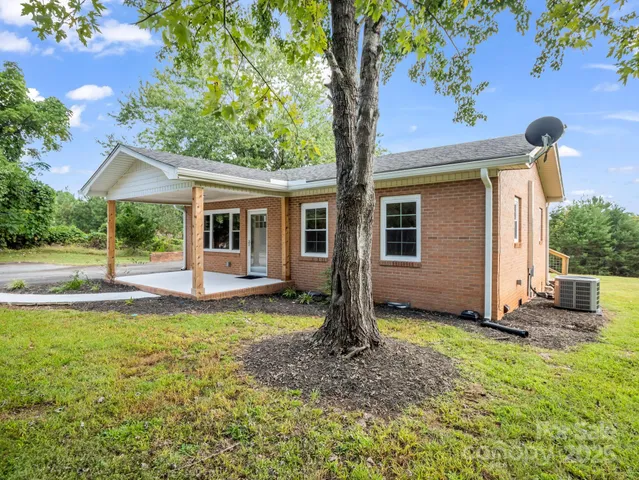 a view of a house with backyard porch and sitting area