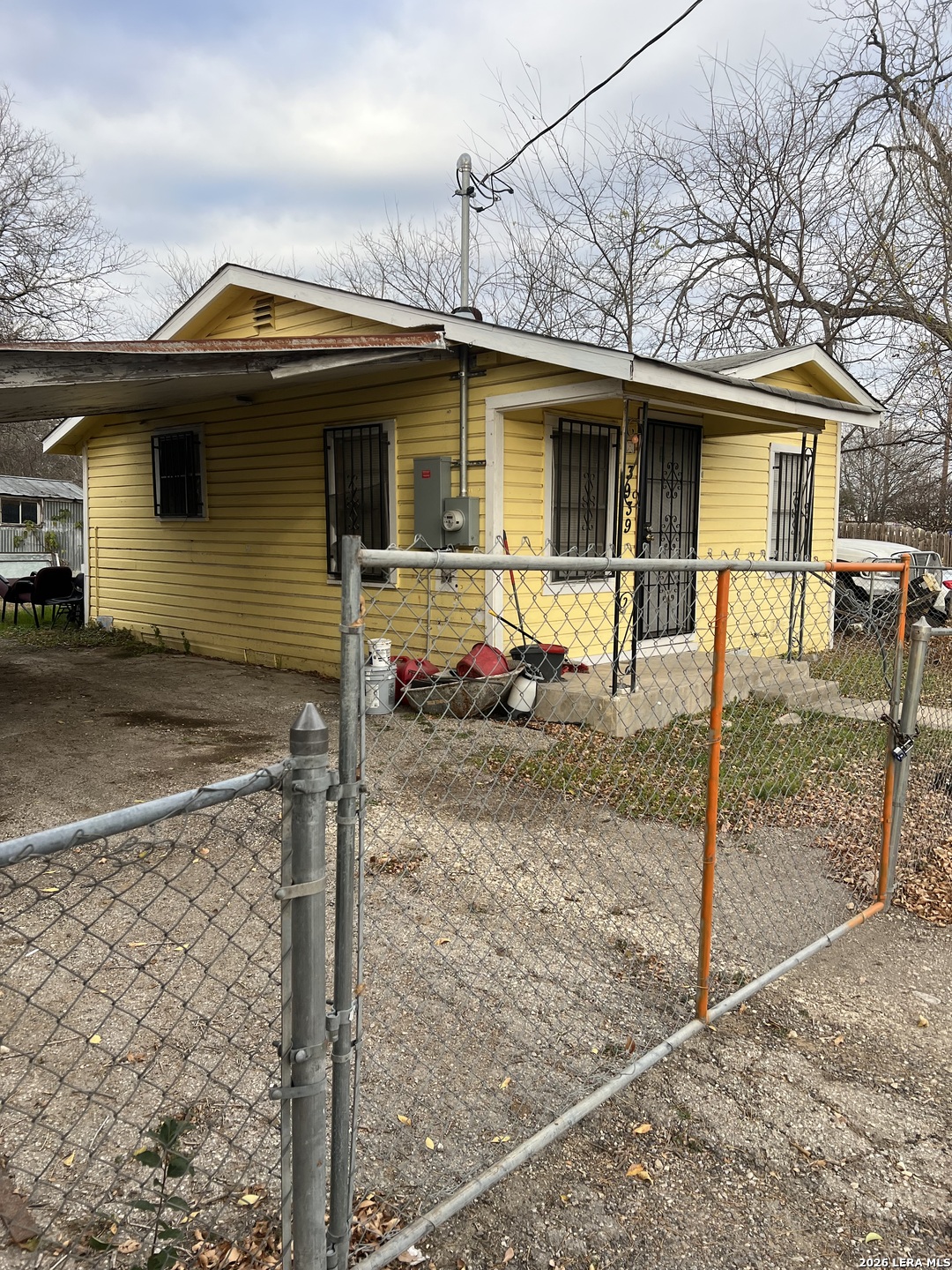 a view of a house with wooden fence