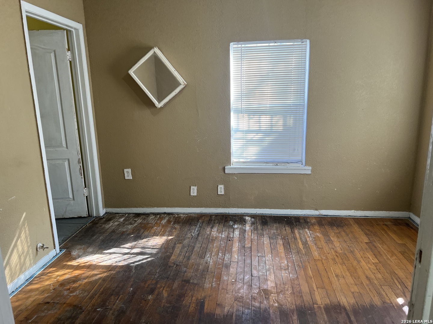3939 Culebra Road San Antonio, TX 78228 - Photo 7 of 8 an empty room with wooden floor and windows