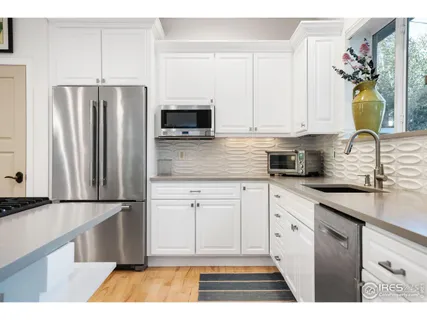a kitchen with stainless steel appliances granite countertop a refrigerator sink and microwave
