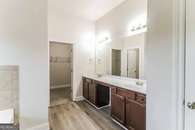 a spacious bathroom with a granite countertop sink mirror and