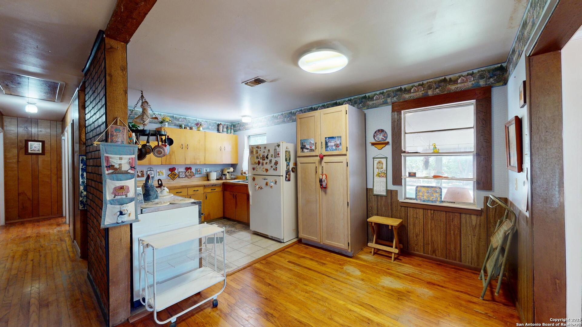 607 Exchange Schertz, TX 78154 - Photo 11 of 34 a view of a kitchen with refrigerator and wooden floor
