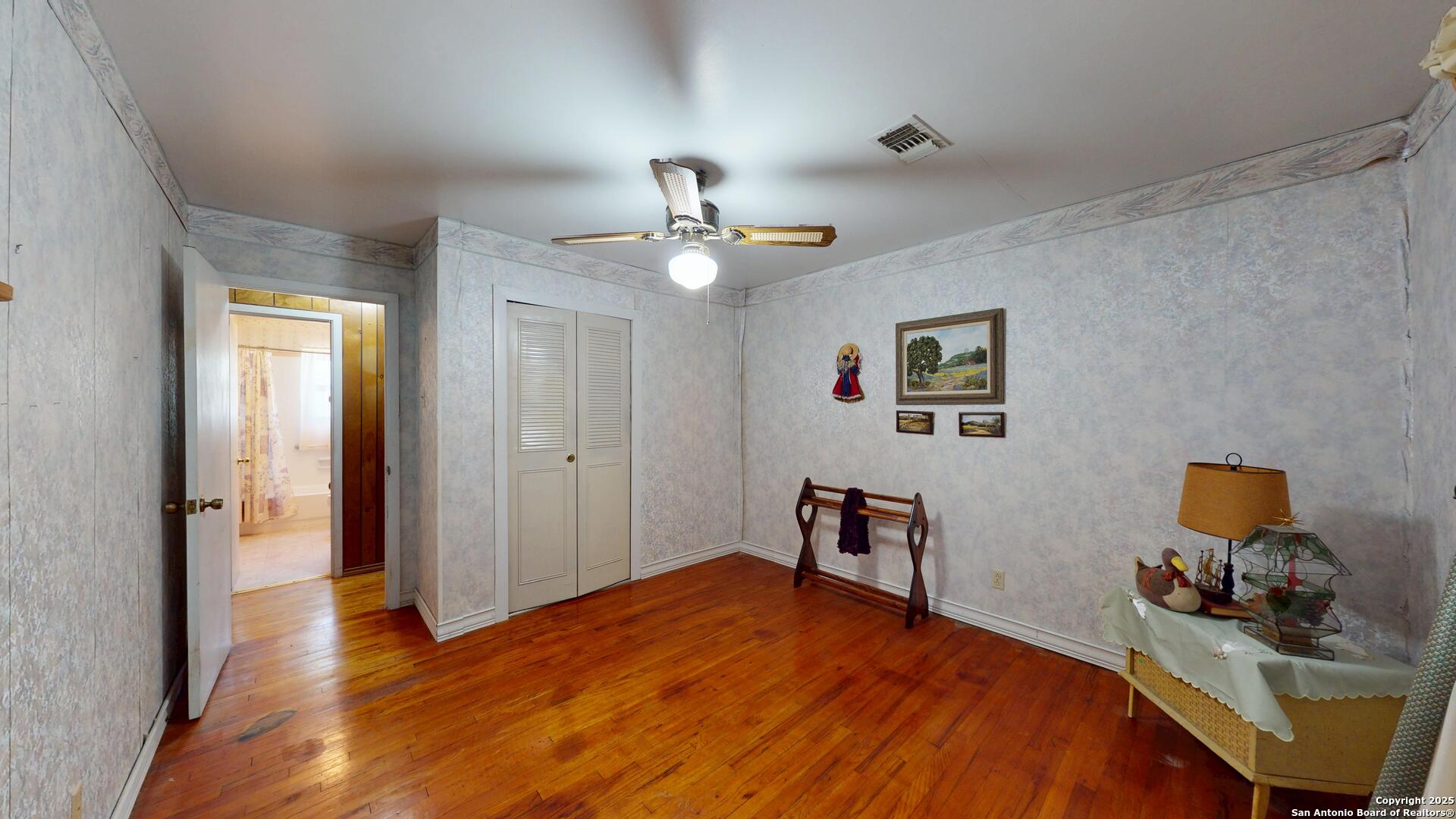 607 Exchange Schertz, TX 78154 - Photo 19 of 34 a bedroom with a bed and a chandelier