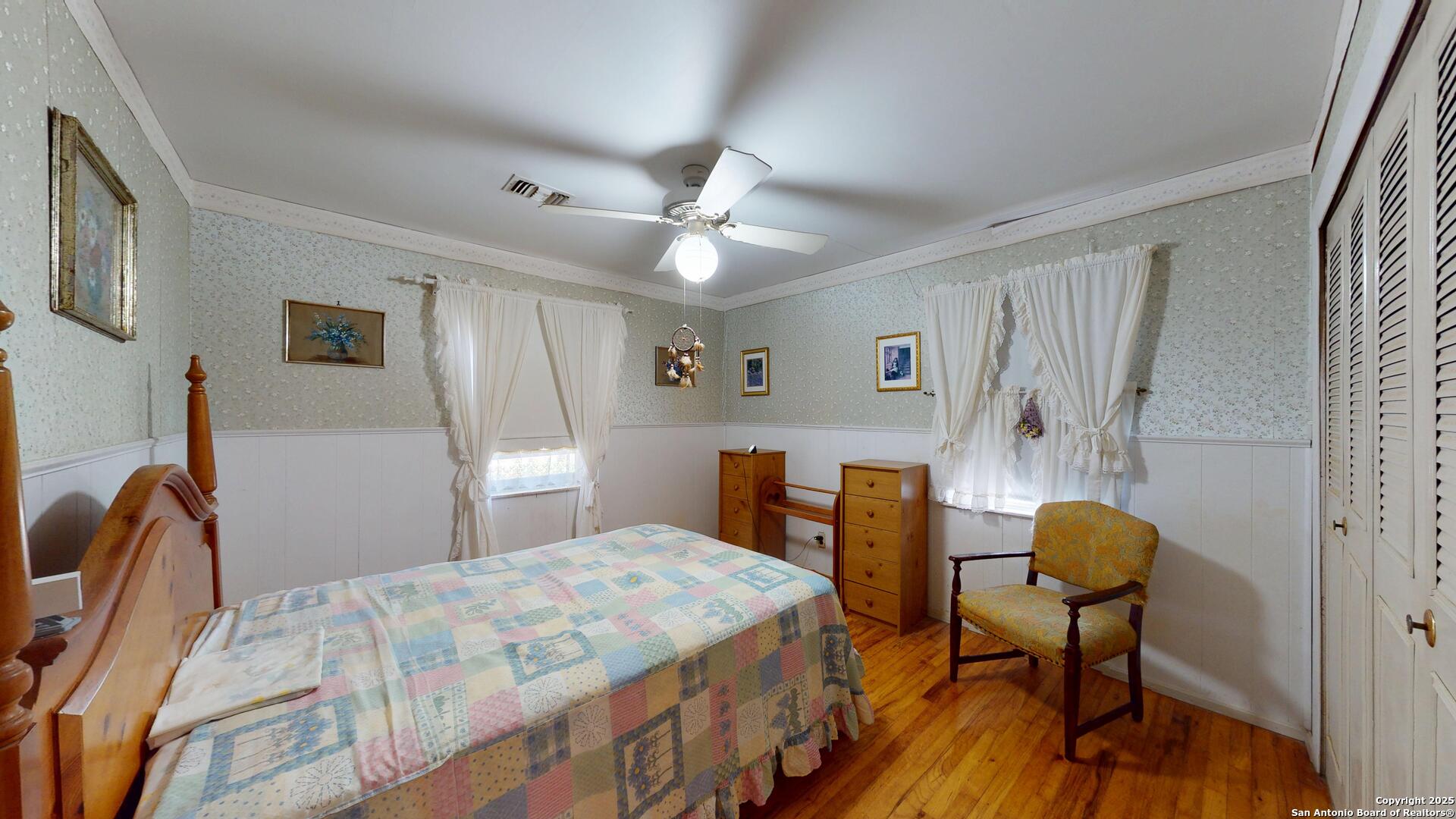 607 Exchange Schertz, TX 78154 - Photo 20 of 34 a bedroom with a bed and a chandelier