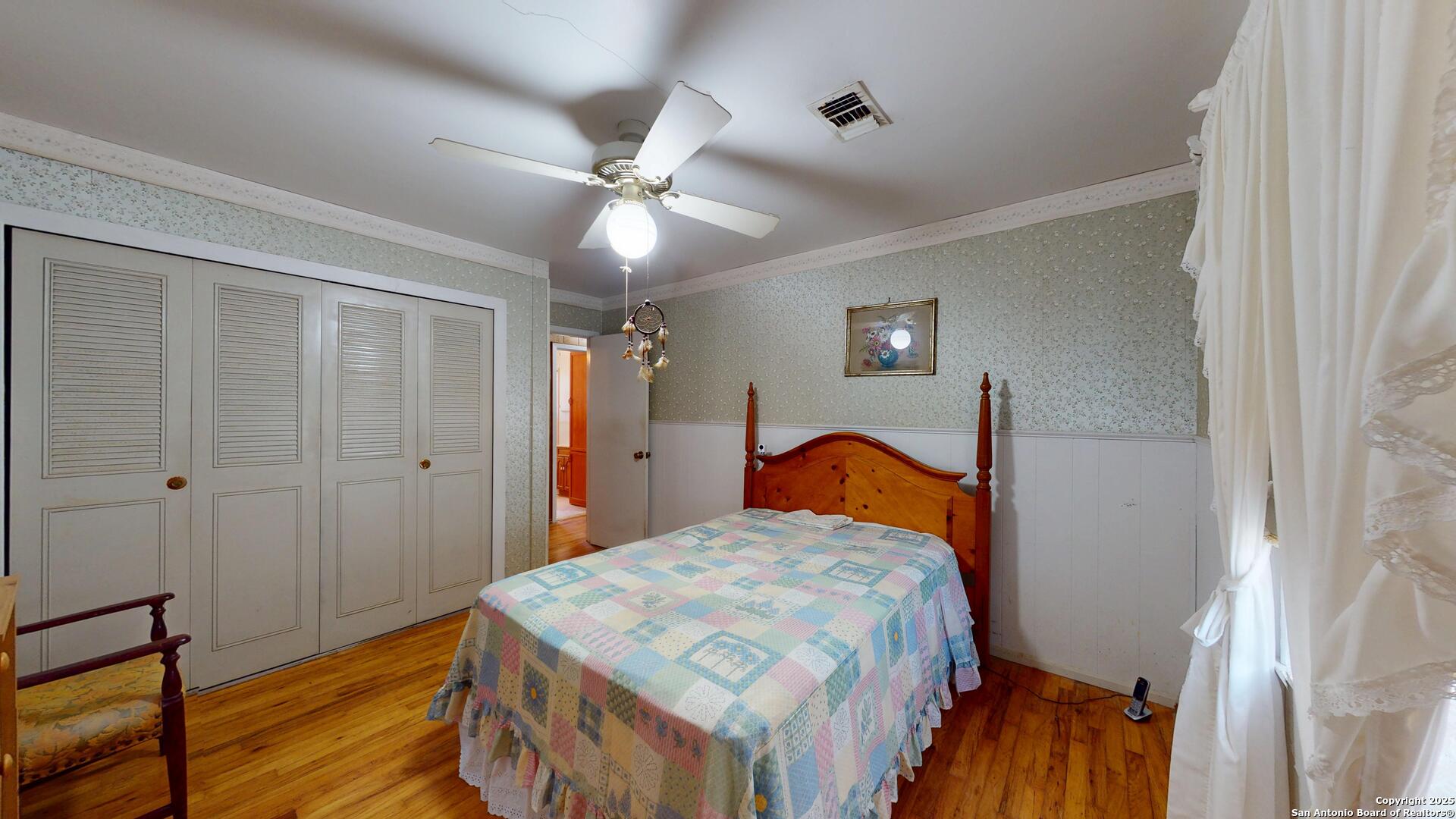 607 Exchange Schertz, TX 78154 - Photo 22 of 34 a bedroom with a bed and a chandelier