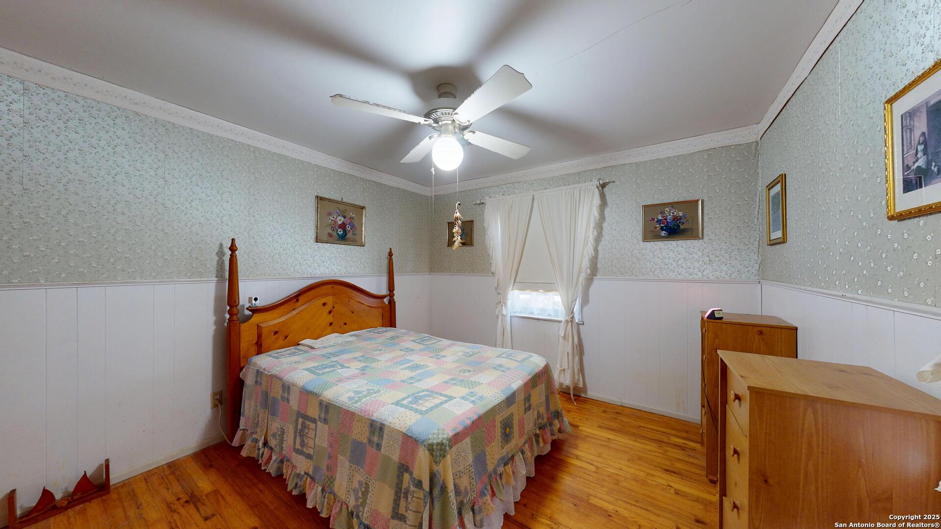 607 Exchange Schertz, TX 78154 - Photo 23 of 34 a bedroom with a bed and wooden floor