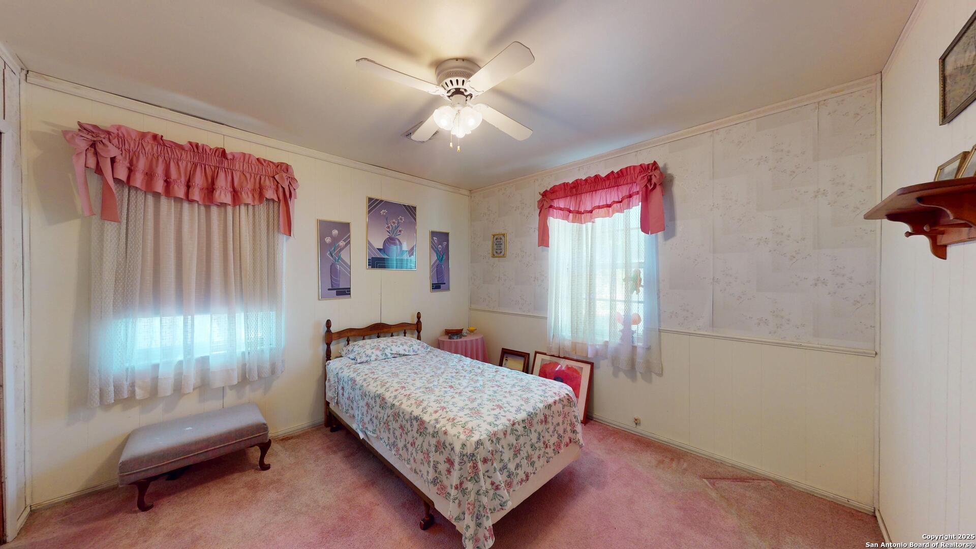 607 Exchange Schertz, TX 78154 - Photo 25 of 34 a bedroom with a bed and a chandelier