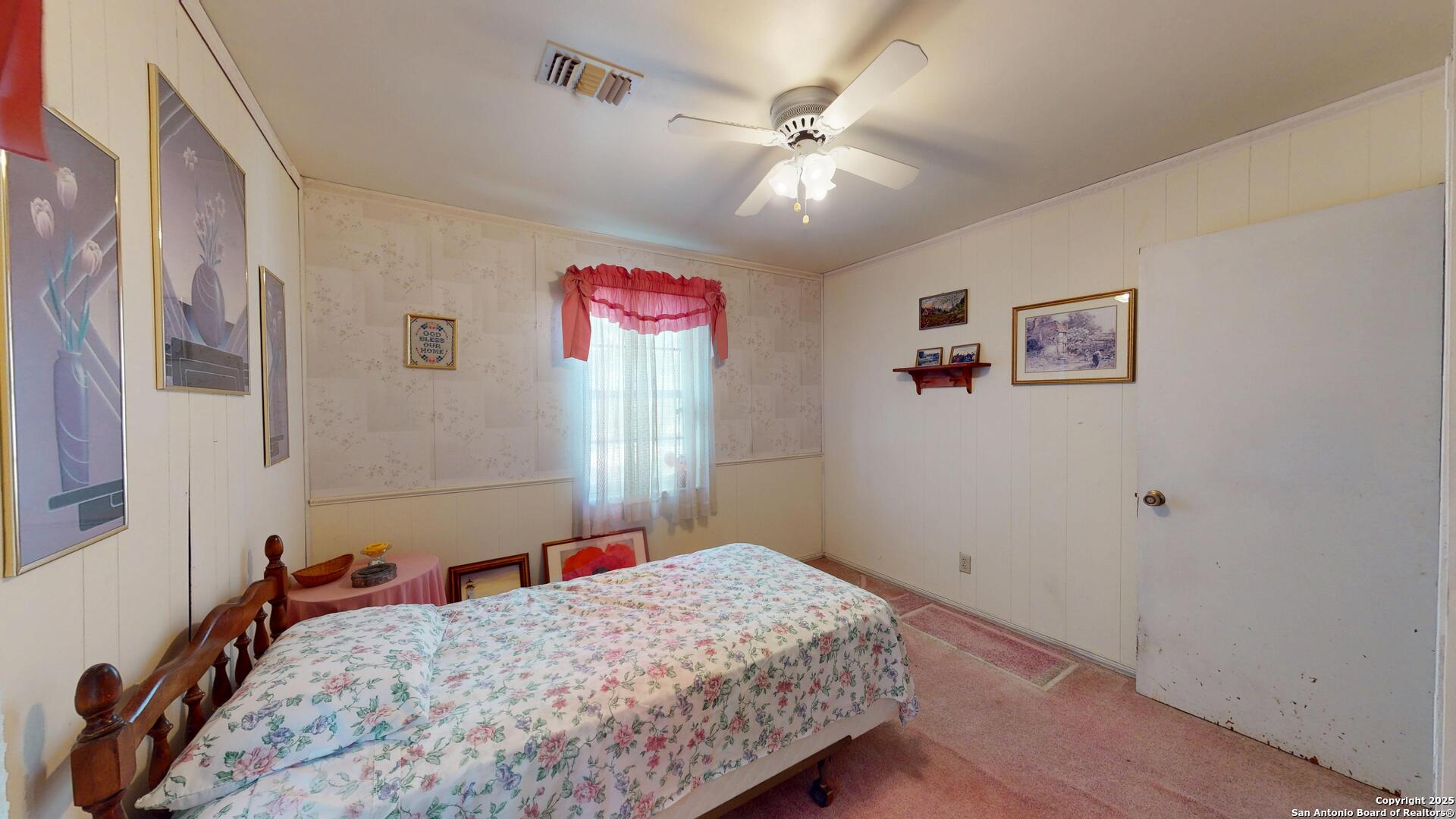 607 Exchange Schertz, TX 78154 - Photo 26 of 34 a bedroom with a bed and a chandelier