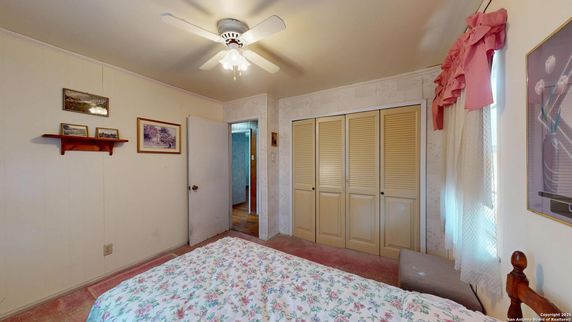607 Exchange Schertz, TX 78154 - Photo 27 of 34 a bedroom with a bed and a chandelier
