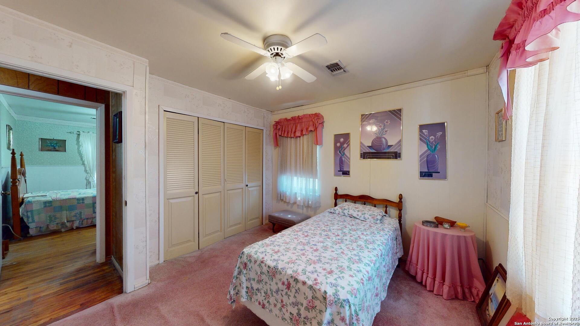 607 Exchange Schertz, TX 78154 - Photo 28 of 34 a bedroom with a bed and a chandelier