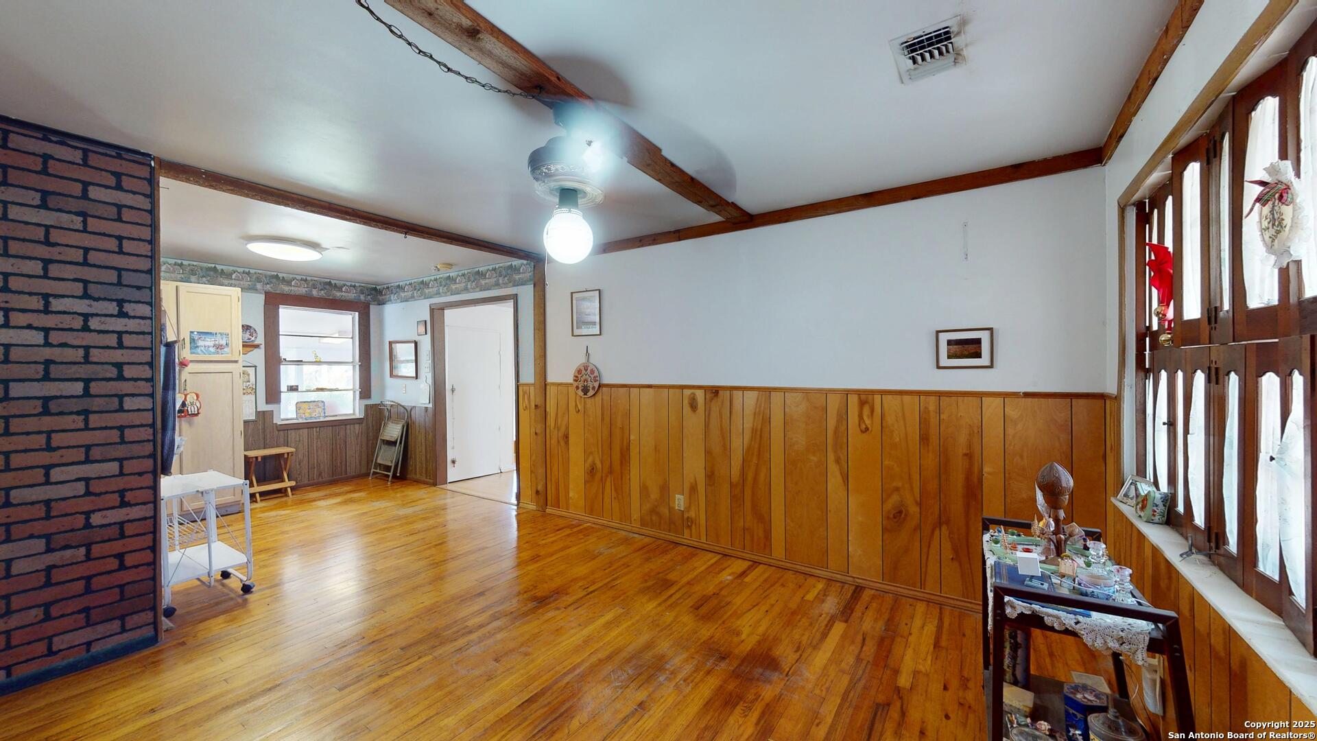 607 Exchange Schertz, TX 78154 - Photo 8 of 34 a view of an empty room with wooden floor and a window