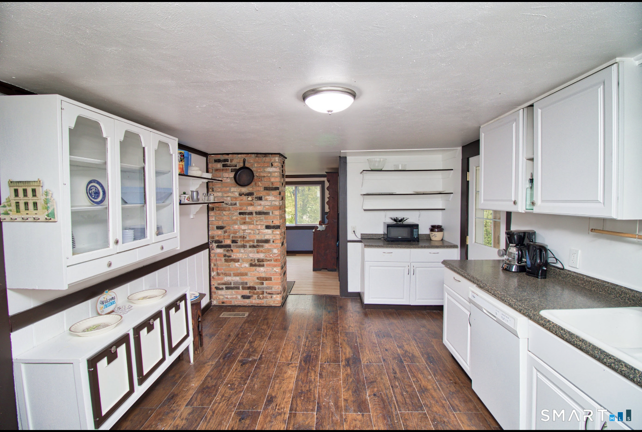 15 Lower Road North Canaan, CT 06018 - Photo 15 of 36 a kitchen with stainless steel appliances a white stove top oven a refrigerator a sink and dishwasher with wooden floor