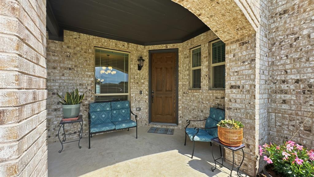 5216 Troupe Road McKinney, TX 75071 - Photo 2 of 40 Covered front porch featuring a brick facade with an arched entry