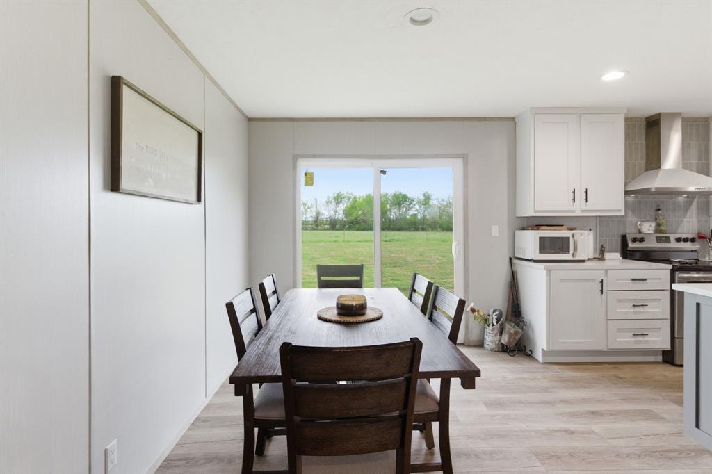 8792 Highway 67 Saltillo, TX 75478 - Photo 17 of 40 a view of a dining room with furniture window and wooden floor