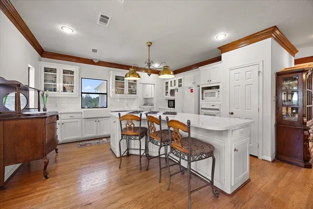 a kitchen with stainless steel appliances kitchen island granite countertop a stove a sink a refrigerator and cabinets