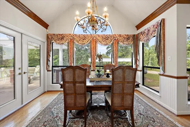 a living room with furniture and a floor to ceiling window