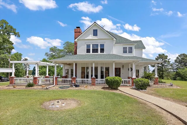 a front view of a house with swimming pool and outdoor seating
