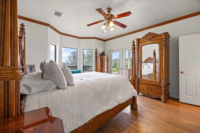 a bedroom with a large bed and a large window