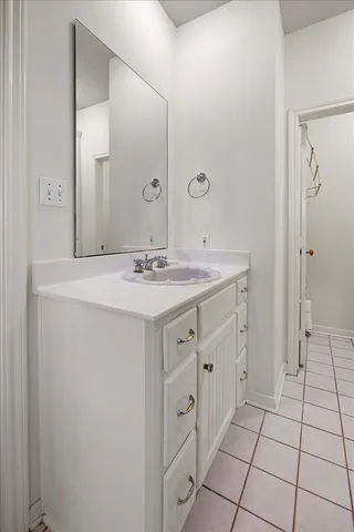 a spacious bathroom with a shower sink and mirror